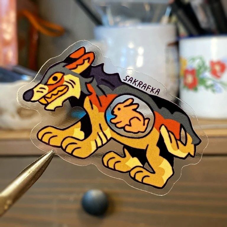 Four stickers of animals in a stylized art style (wolf, pike, lizard and owl). The stickers are see-through, and all the animals have a transparent part on their body with their most common prey animal inside.