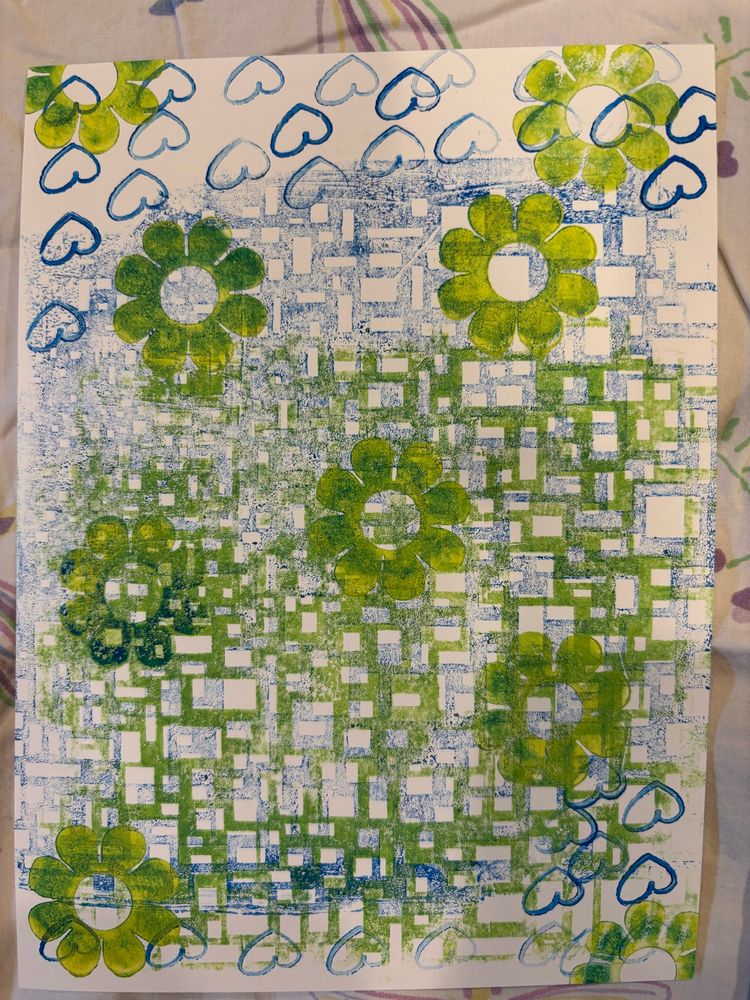 Gelli printed white rectangular paper with a mix of blue and green quadrangles, flowers and hearts.