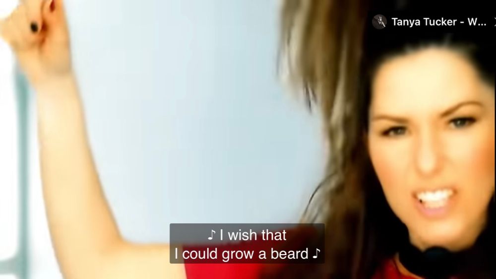 Screencap from shania Twain’s music video for Up! Subtitles read: I wish that I could grow a beard.