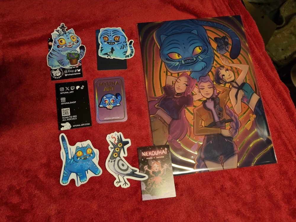 Picture of my K-pop Demon Hunters haul. There's an A4 sized print of Huntrix lying down, being relaxed, with Derpy and Sussy, a Derpy pin with a small potted plant that's on its side, three Derpy stickers, two of which also have Sussy on there, and a Sussy sticker. The artists' business cards are displayed alongside them and tagged in the post