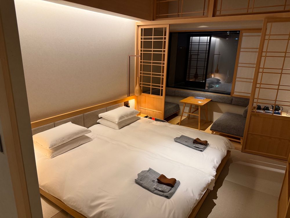 a hotel room with two beds that are made to look like futons in ryokan style inn