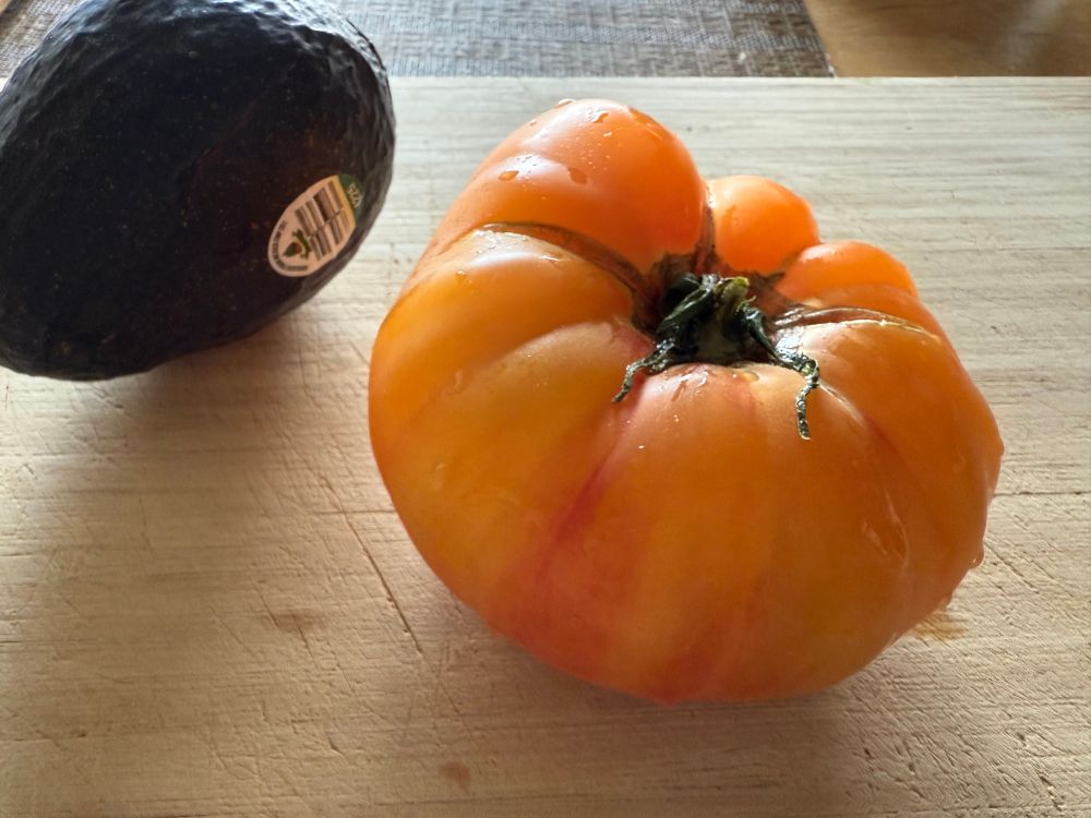 big heirloom tomato with reddish yellow skin