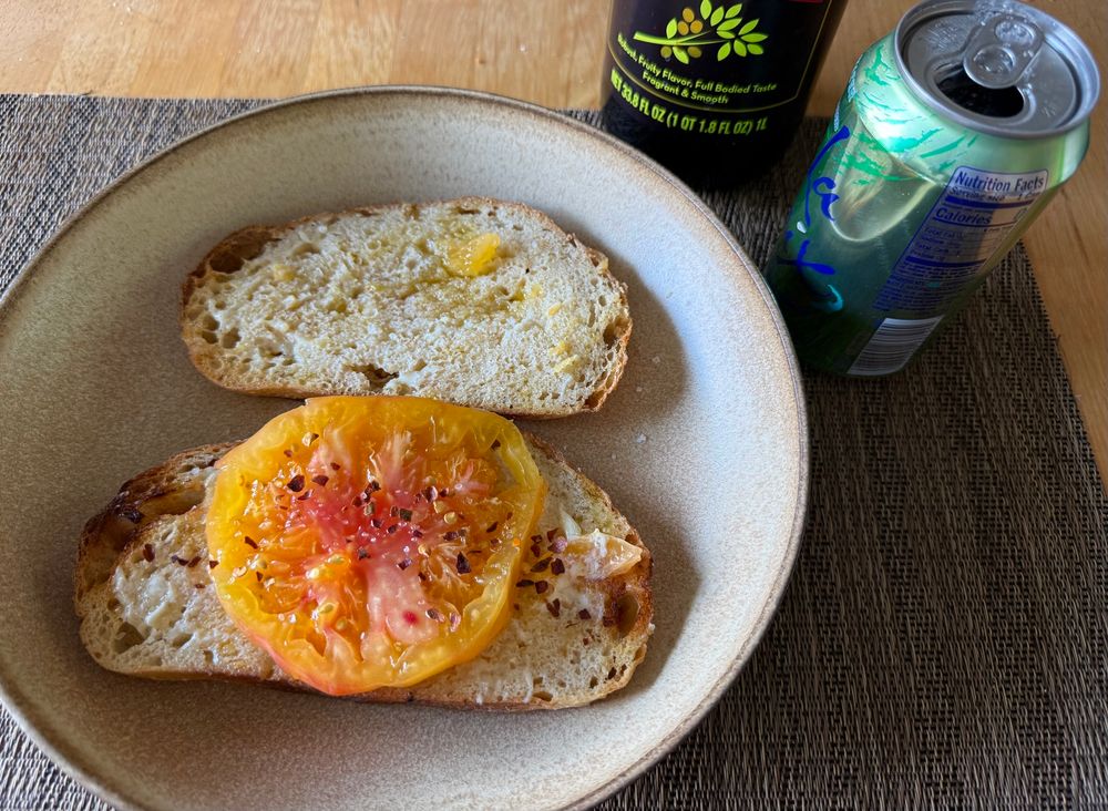 tomato sandwich with a can of lime soda 