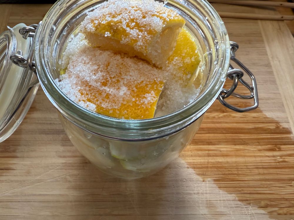 cut lemons in a glass jar sprinkled with kosher salt
