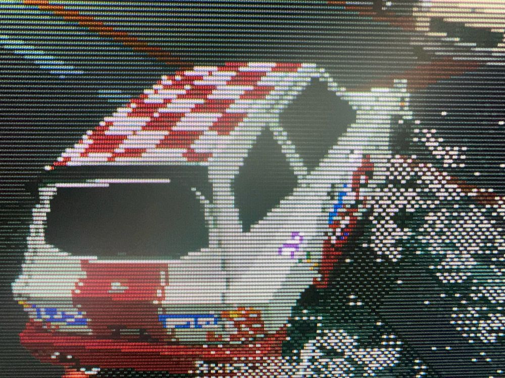 A closeup of the game Parking Garage Rally Circuit running on a classic CRT monitor showing the scanlines and shadow mask.