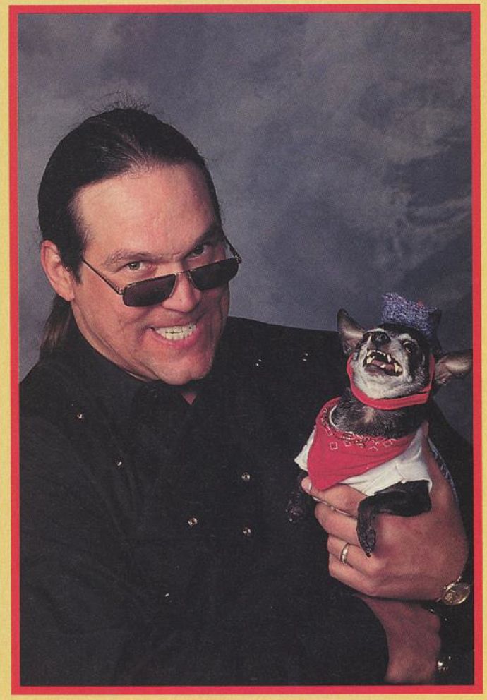 an image from the september 1996 issue of wcw magazine with steve "mongo" mcmichael in a black button-up holding pepe, pepe is wearing a white shirt, blue and white patterned cowboy hat, and his red bandana, both mongo and pepe are growling at the camera, they're very ferocious