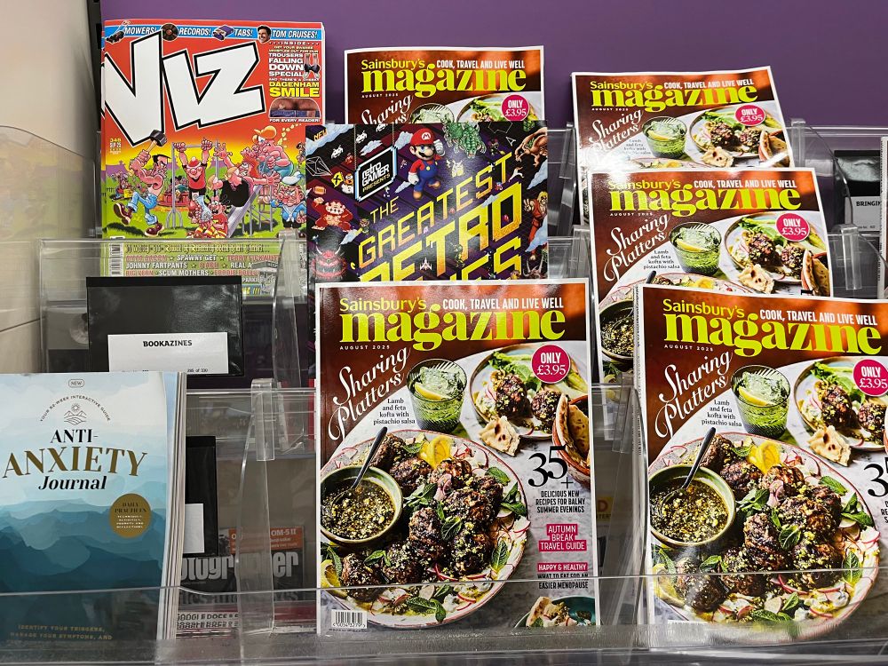 Retro Gamer Presents: The Greatest Retro Games Of All Time on the shelves, surrounded by an Anti-Anxiety Journal, Viz, and five copies of Sainsbury’s Magazine.