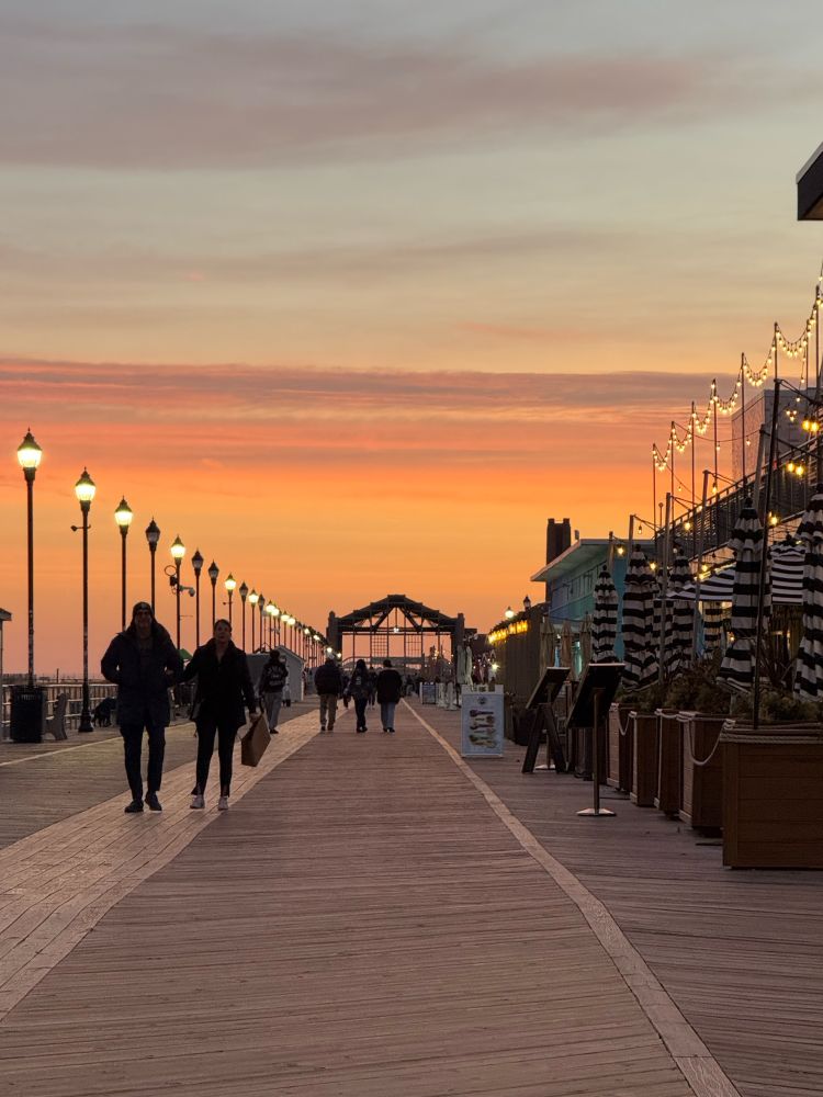 The Casino at the other end of the boardwalk with orange skies above it