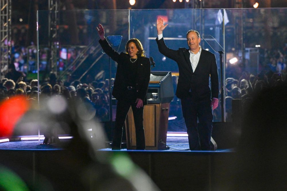 VP Harris and Second Gentleman Doug Emhoff wave to the crowd