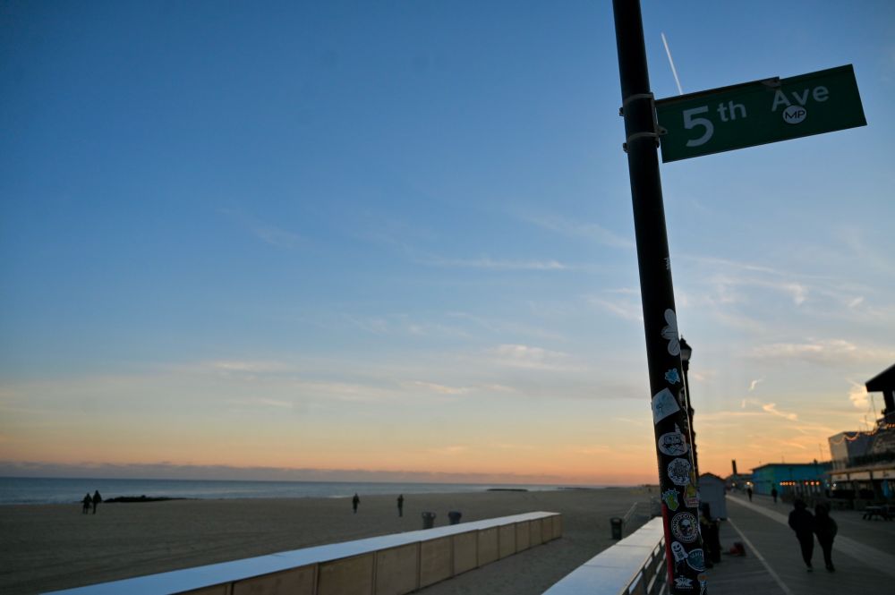 5th avenue street sign on the boardwalk at sunset 