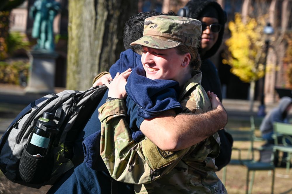 A ROTC student hugs a friend