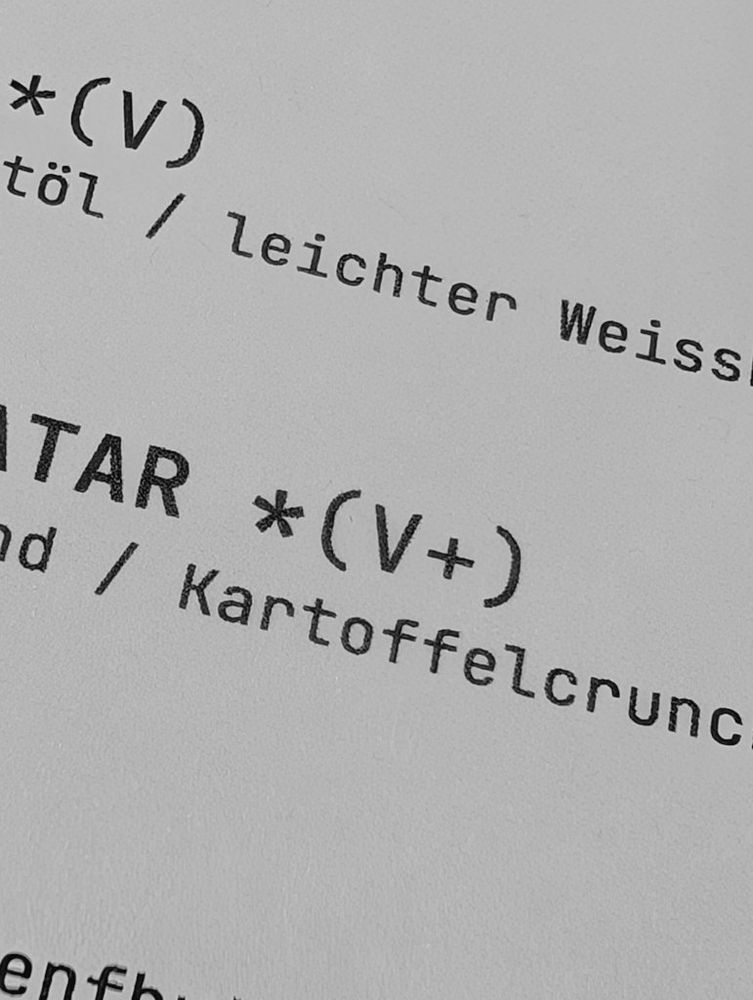 A restaurant menu with *(V) and *(V+) 