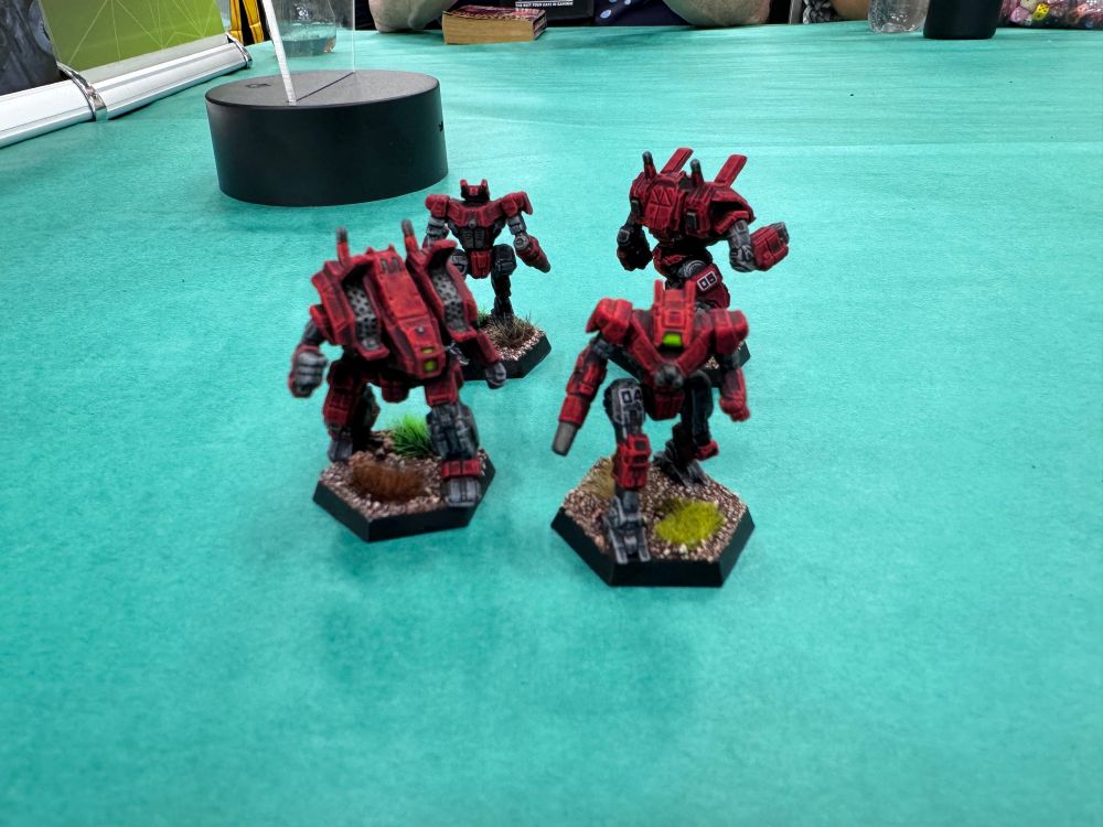 Four BattleMechs—two Archers and two Wolfhounds—painted up in the red and black of the Kell Hounds. 