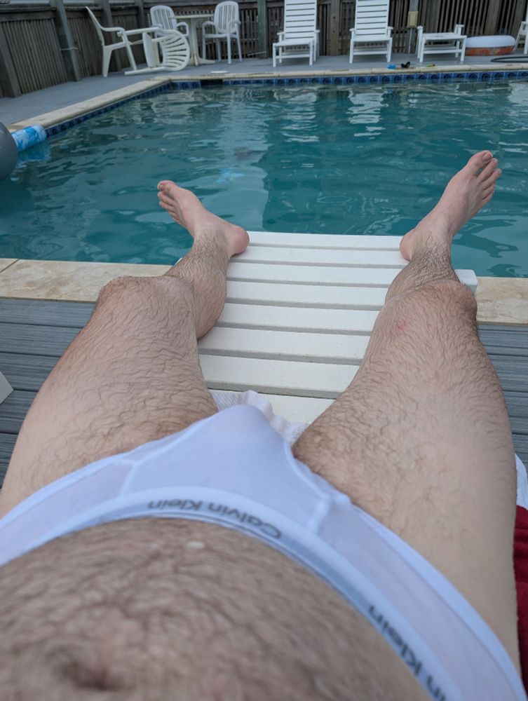 a pic of me looking down my legs at the pool and overlooking my soaking wet tighty whities 