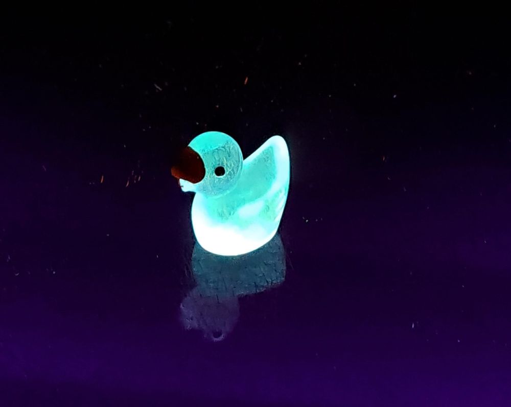 Bright blue fluorescent duck figure