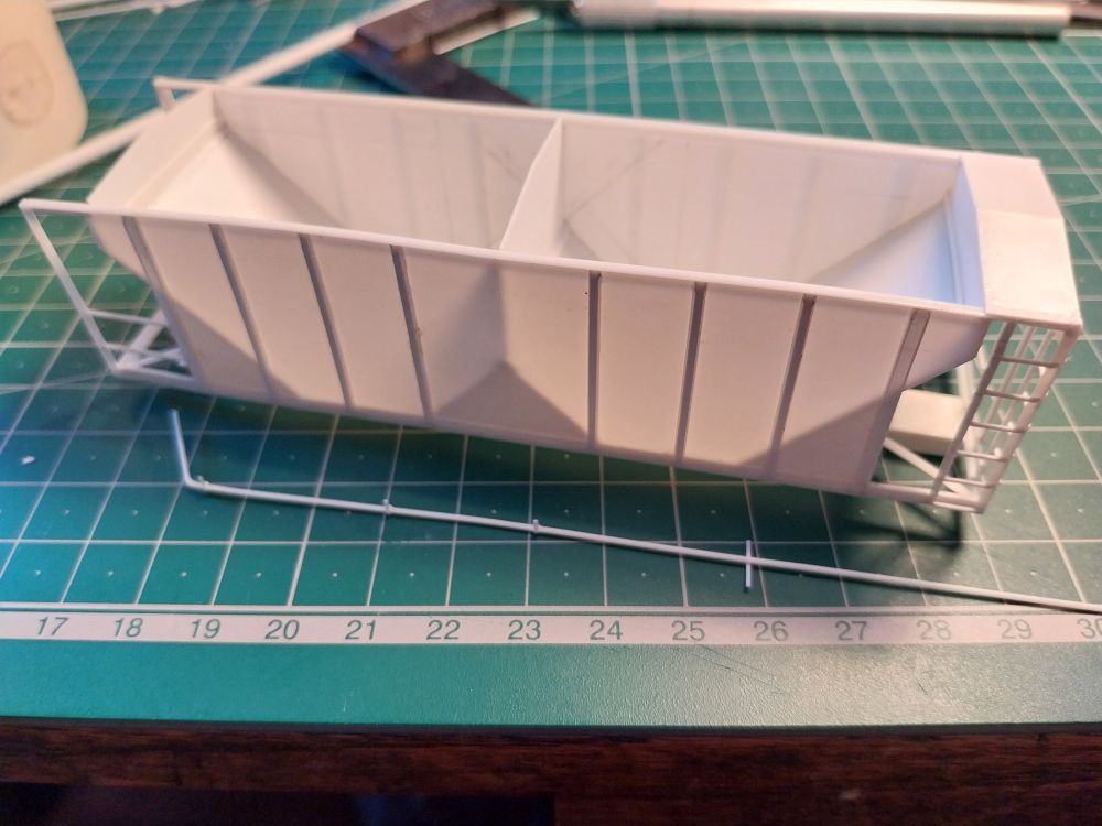Ballast hopper scratchbuilt in styrene, with styrene air line under construction using Evergreen 30 thou rod (210).