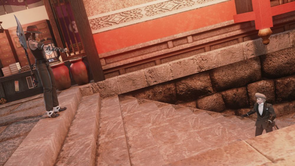 Chivalrous Daisy, dressed like some kind of gangland enforcer, spots her target: a hyur man in a suit and a large pompadour. She points accusingly at him from the top of a set of stairs.