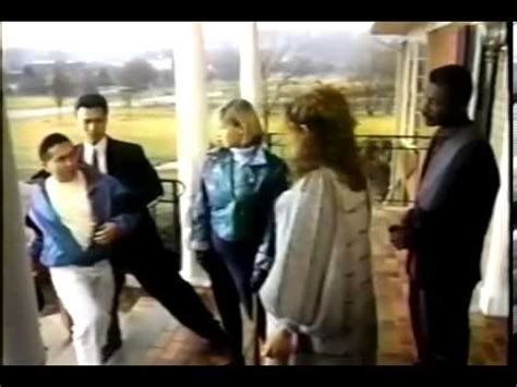 A group of very 1980s people gathered in the front yard of an extremely northern Virginia suburban home, as featured in Cynthia Rothrock film Honor and Glory