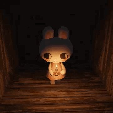 a bunny rabbit is holding a candle in a dark room .