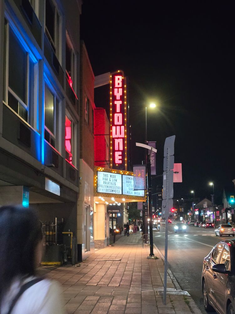 photo of the marquee sign for the bytowne cinema showing a selection of movies and city lights