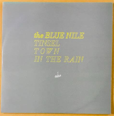 A record cover blank with the words the BLUE NILE
TINSEL
TOWN
IN THE RAIN
written in yellow handrawn font.