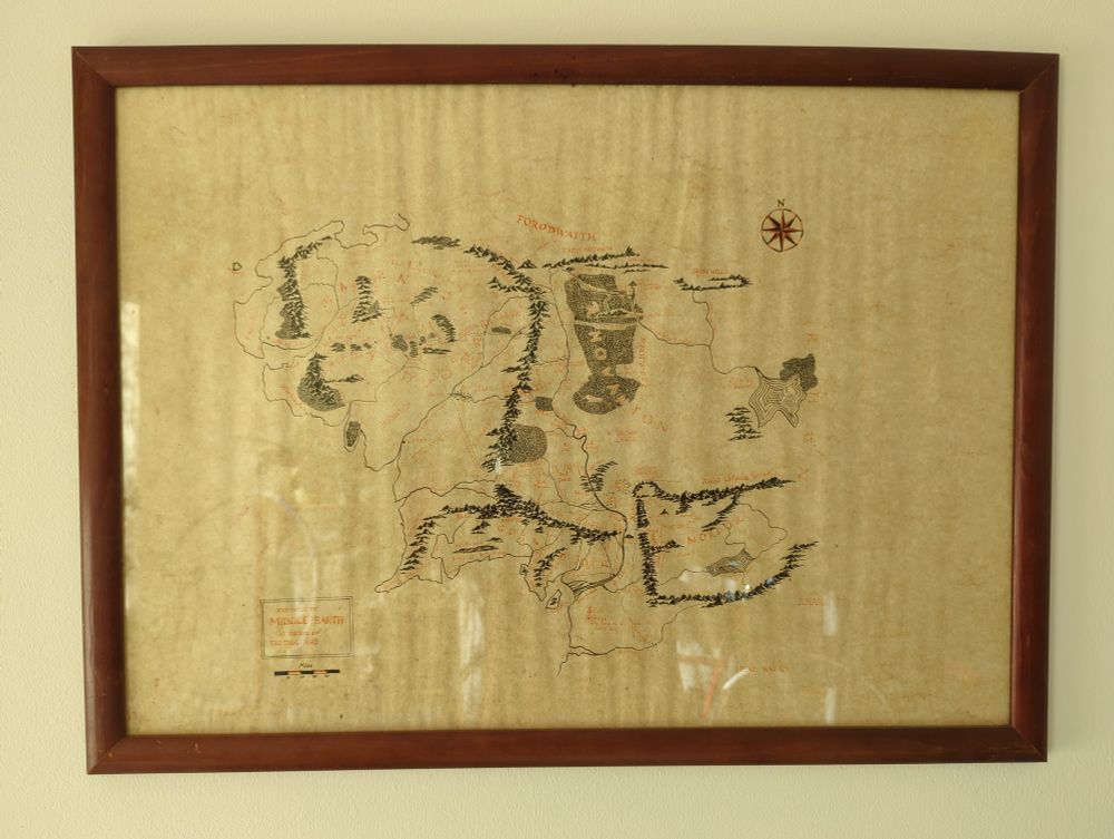 A wooden frame holds a map of Middle Earth (copied from the map in the book) behind glass. The red ink is somewhat faded. 