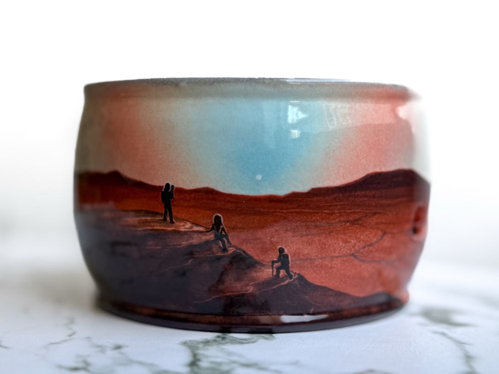 Yarn bowl featuring three hikers on a Martian landscape at sunset.