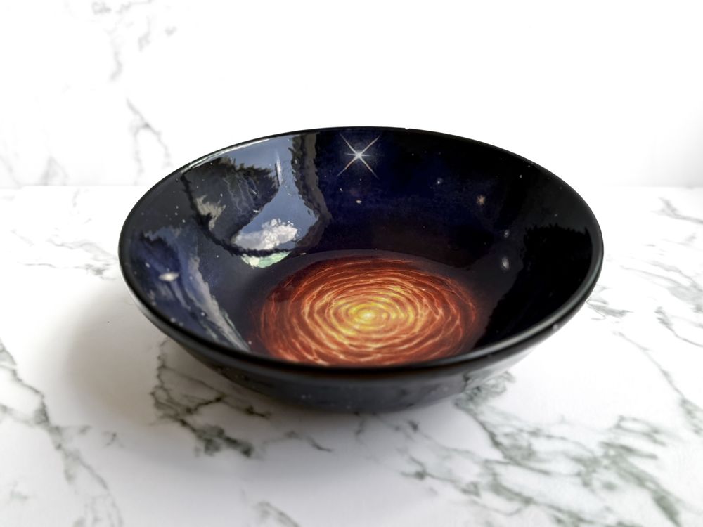 Bowl featuring star resembling CW Leonis and surrounding galaxies. (Side). 