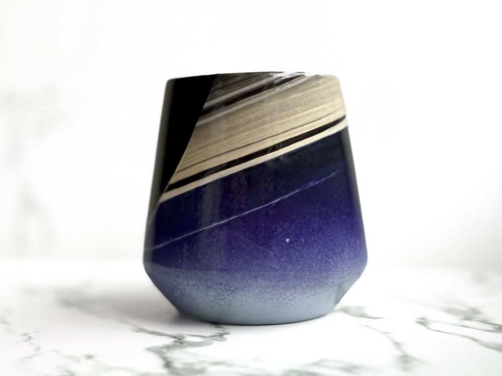 Angled cup featuring a hand painted design resembling the Cassini capture of Earth from Saturn as the "pale blue dot"