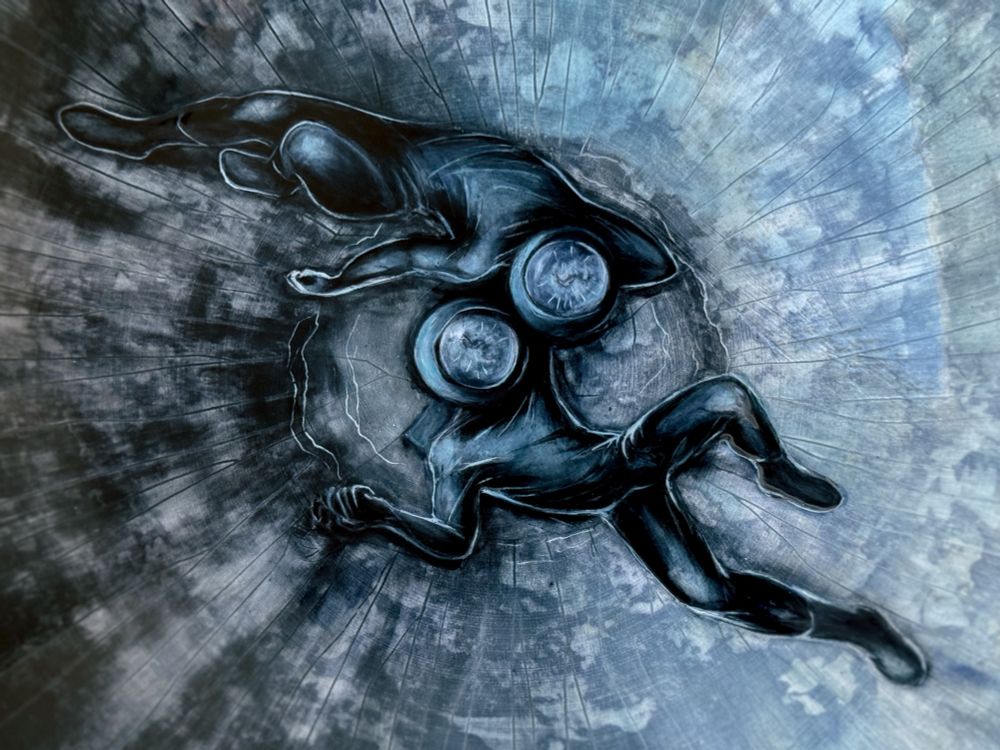 Serving bowl featuring two astronauts laying in a crater with heads close together. They are in a similar pose to the shape of the galaxy in the previous bowl. The galaxy is reflected in their visors. The viewer is looking straight down into the crater. (Detail of astronauts)