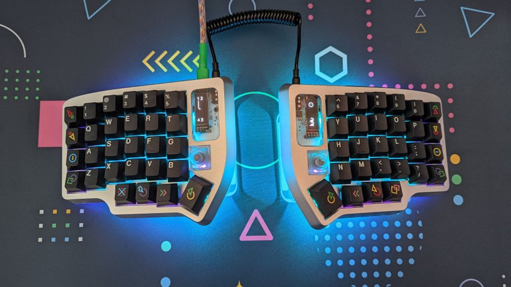 An ergonomic keyboard called the Lulu that has blue underglow lights and GMK Polybius keycaps
