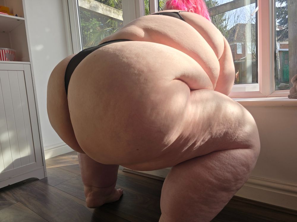 Ssbbw squatting and her ass is facing the camera.