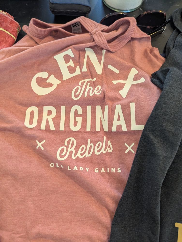A salmon colored tank with the words 