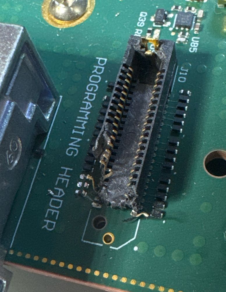 Damaged programming header on an Oxide Cosmo EVT board.