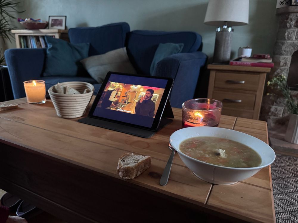 Table with soup bowl bread and ipad
