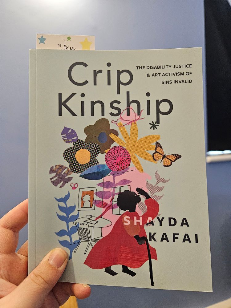 Crip Kinship, a small blue book with a beautiful cover with colourful flowers and a black person in an orange dress walking with a stick