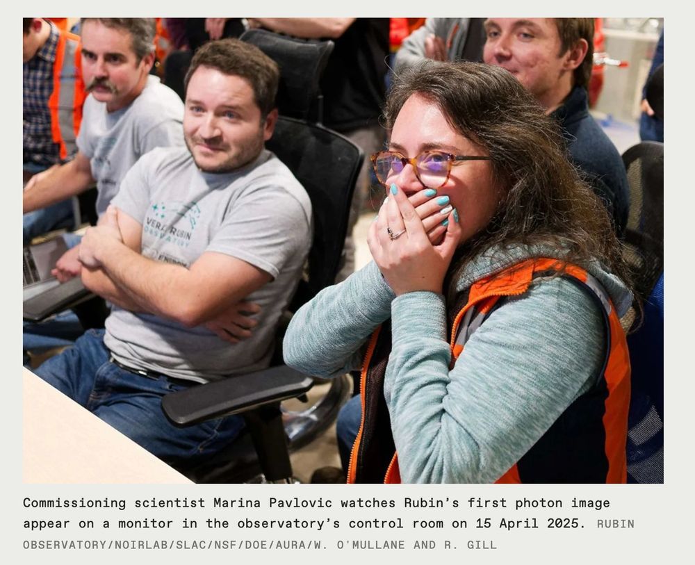 photo of a scientist with hands over her mouth in a crowd of people. Caption reads: Commissioning scientist Marina Pavlovic watches Rubin’s first photon image appear on a monitor in the observatory’s control room on 15 April 2025. Rubin Observatory/NOIRLab/SLAC/NSF/DOE/AURA/W. O'Mullane and R. Gill