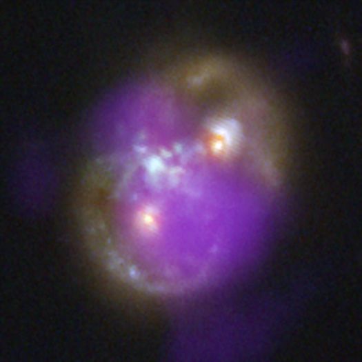 A composite image of the "Infinity Galaxy" with X-rays from NASA's Chandra X-ray Observatory (purple) and infrared data from JWST (red, green and blue).