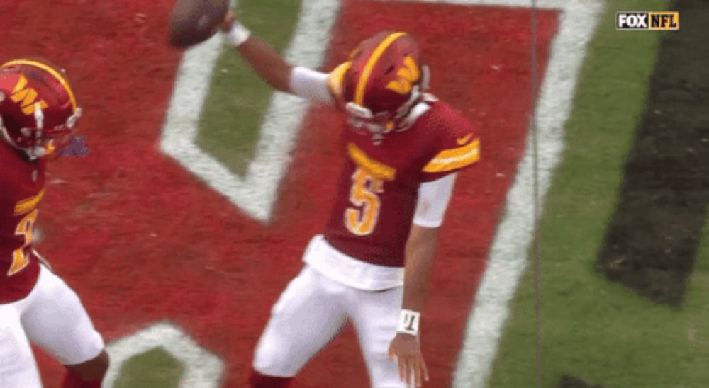 a football player with the number 5 on his jersey throws the ball