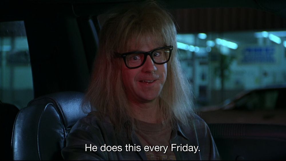 Dana Carvey as Garth from Waynes World, sitting in the Mirth Machine (his car) looking directly at camera, captioned: "He does this every Friday."