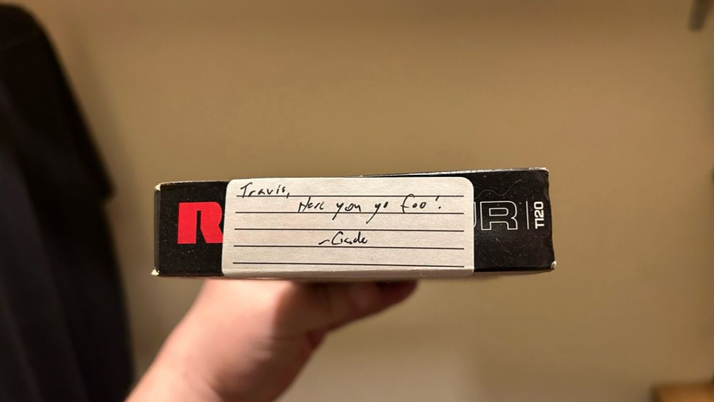 Handwritten label on a VHS tape: “Travis, here you go foo ! - Cade”