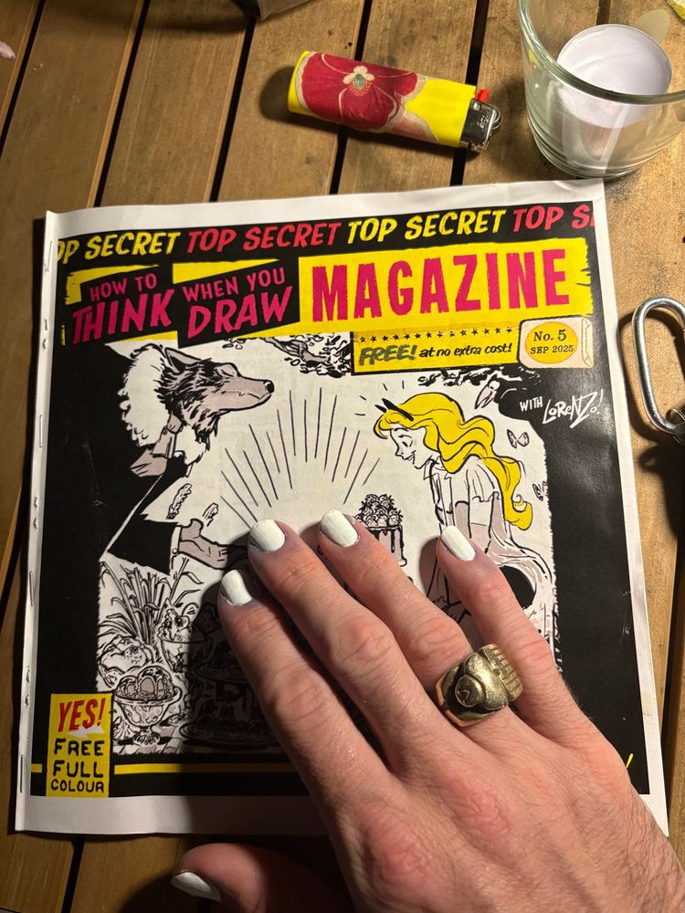 The zine “how to think when you draw” and white nails with a brass ring