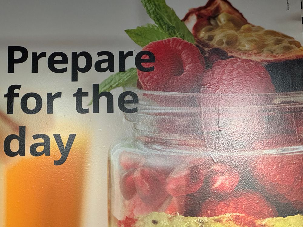 An ominous looking advertisement that says “prepare for the day” next to an insane fruit parfait