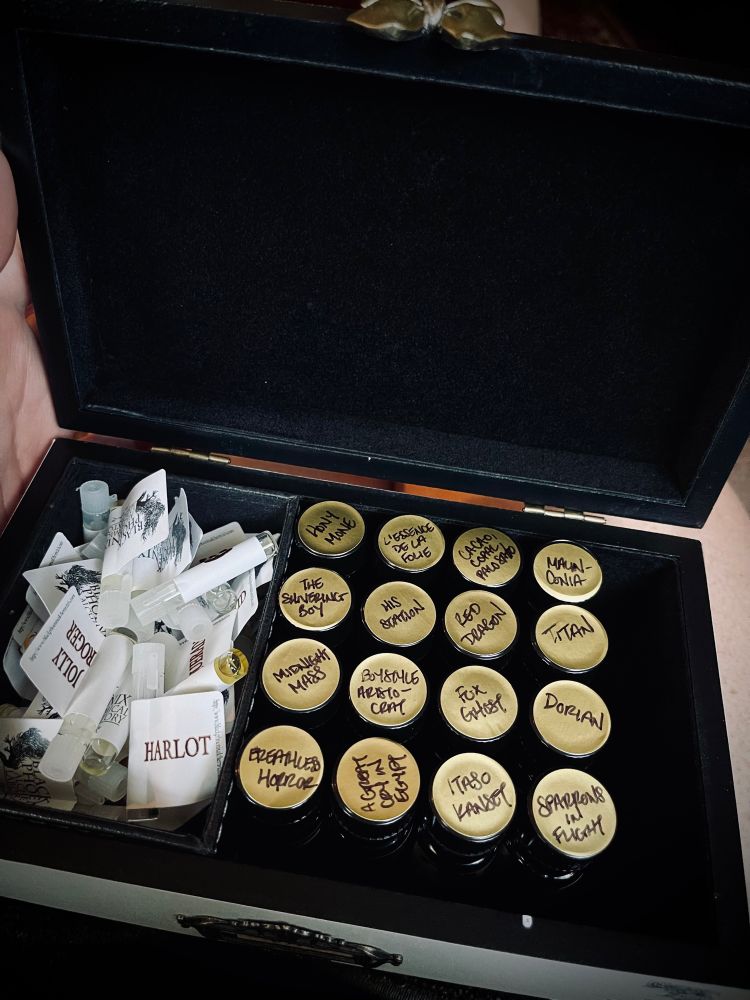 A small box with perfume vials and sample vials from BPAL