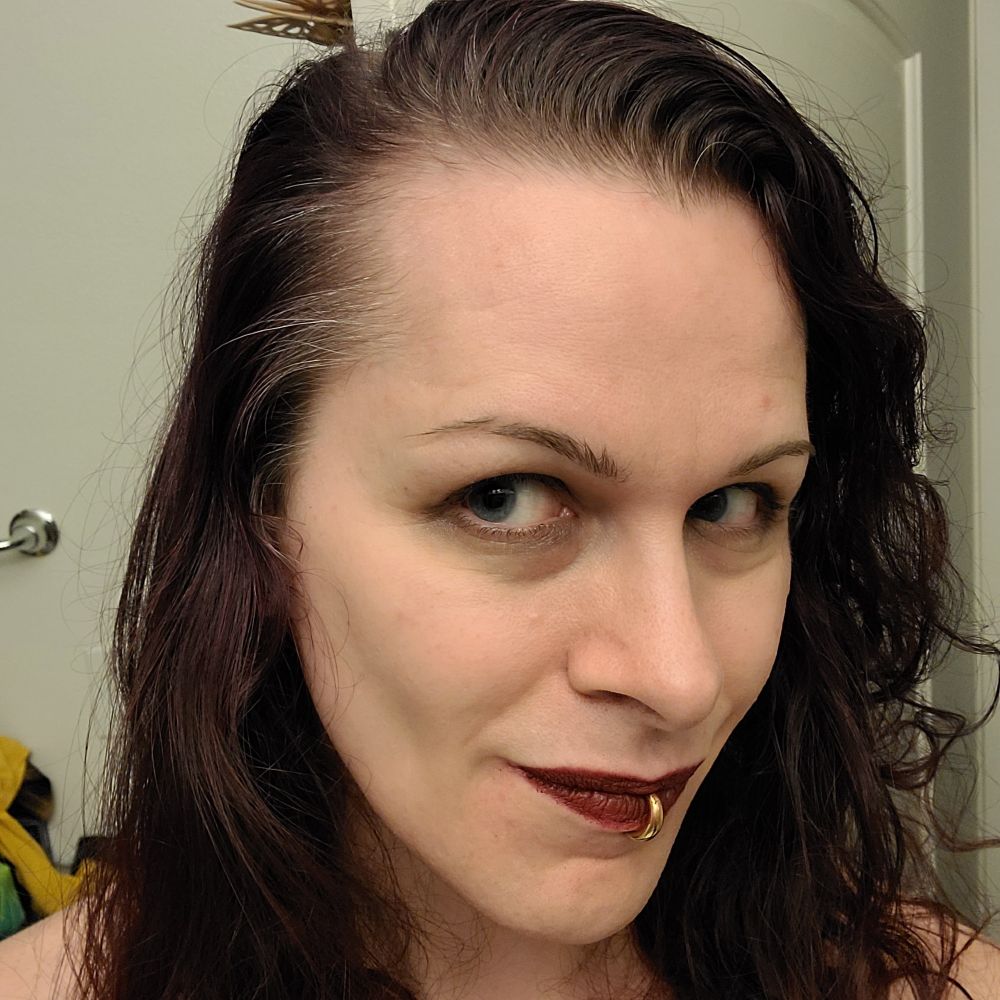 A headshot selfie of Andromeda, grey at her temples. 