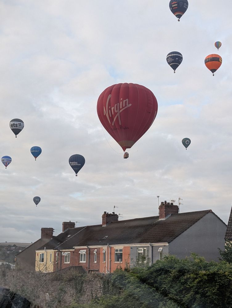A variety of hot air balloons in the sky above Bristol