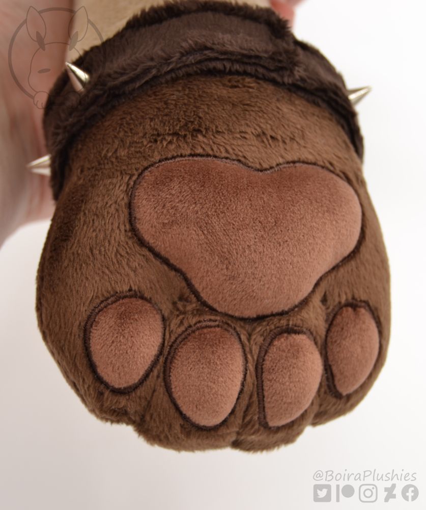 close up shot of our handmade gnoll plush, showing the squishy toe beans and hand thread sculpting