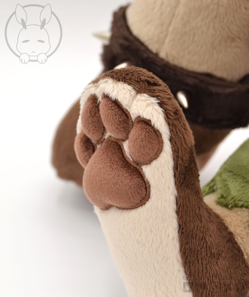 close up shot of our handmade gnoll plush, showing the feet toe beans