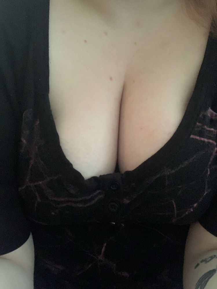 A close up of cleavage in a black dress 