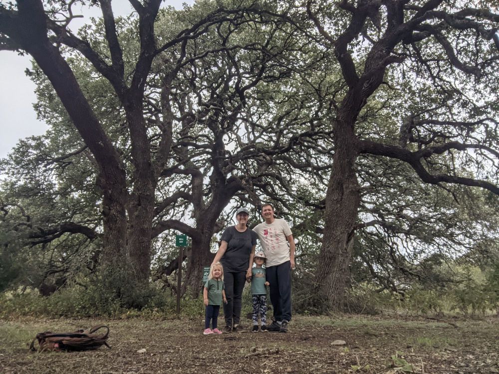 Parents and children in front of The Bell Oak at River Ranch Park in central Texas.